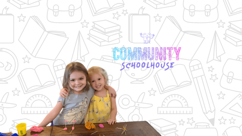 Two students smiling together at Community Schoolhouse.