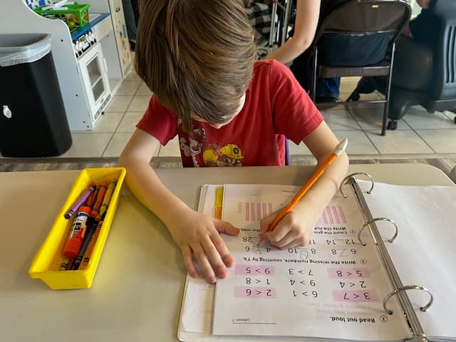 A student focused on independent work at Community Schoolhouse.